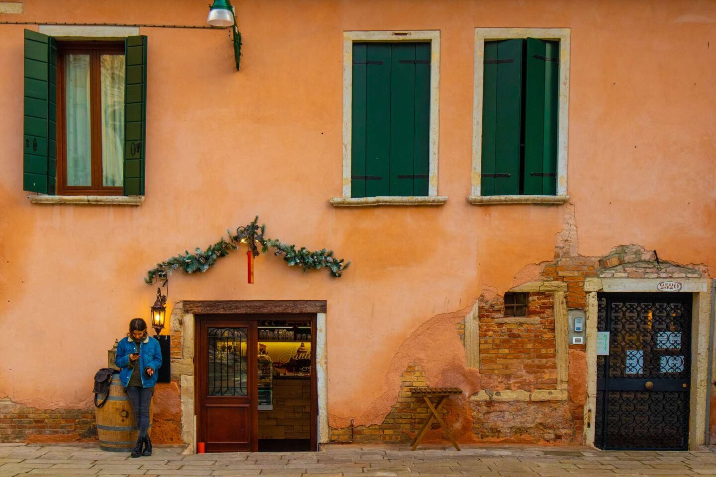 A woman waiting on street in Venice