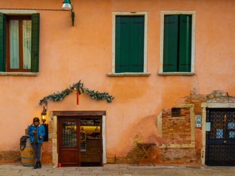 A woman waiting on street in Venice