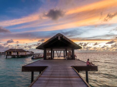 Serene waterfront setting during sunset, representing a 'What If Story' backdrop, captured during a travel to Maldives