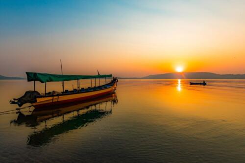 a boat pointing at the sunrise