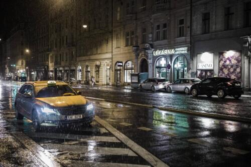 a taxi in the street in a rainy evening